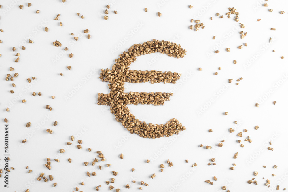 Golden euro sign surrounded with scattered pieces of gold on white background Golden euro sign surrounded with scattered pieces of gold on white background