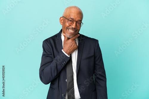 Business senior man isolated on blue background happy and smiling