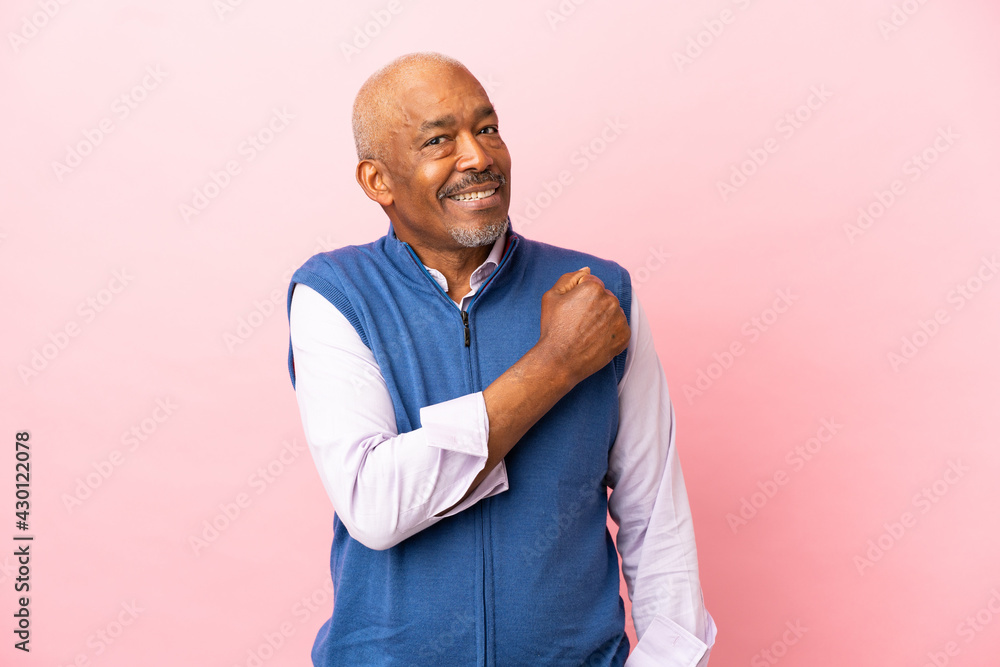 Cuban senior isolated on pink background celebrating a victory Cuban senior isolated on pink background celebrating a victory