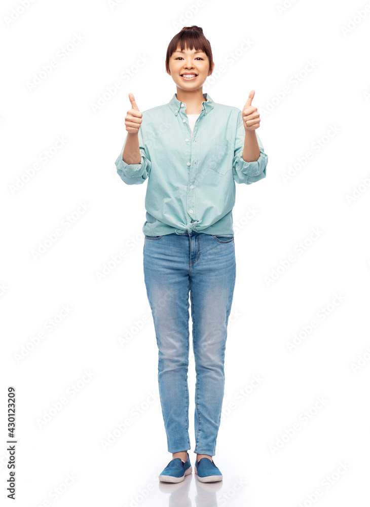 people, ethnicity and gesture concept - happy asian young woman in cotton shirt and jeans over white background people, ethnicity and gesture concept - happy asian young woman in cotton shirt and jeans over white background