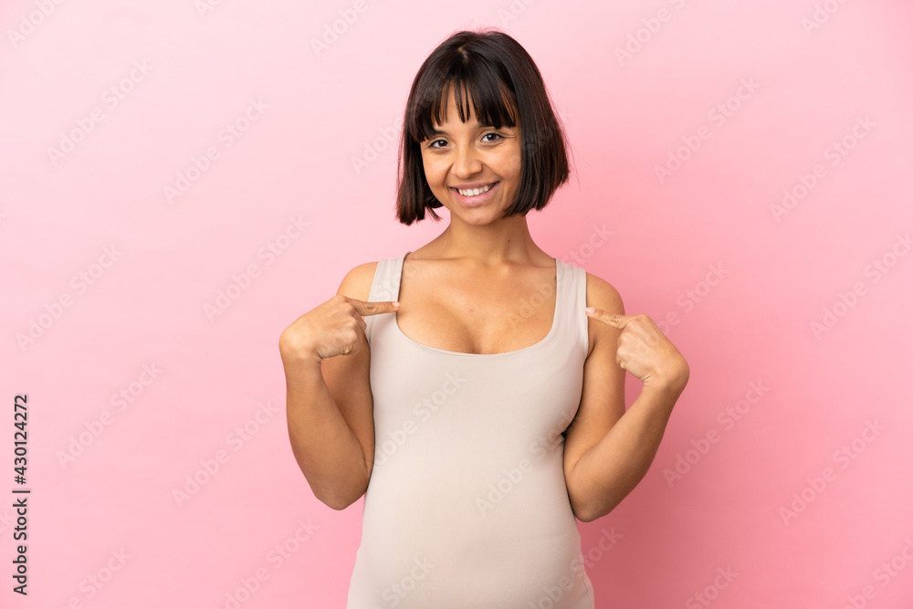 Young pregnant woman over isolated pink background proud and self-satisfied Young pregnant woman over isolated pink background proud and self-satisfied