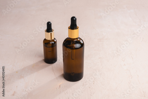 Eco Mineral oil in Amber glass bottles with pipette. Transparent hyaluronic serum gel and skin care concept. Top horizontal view copyspace of dropper glass.