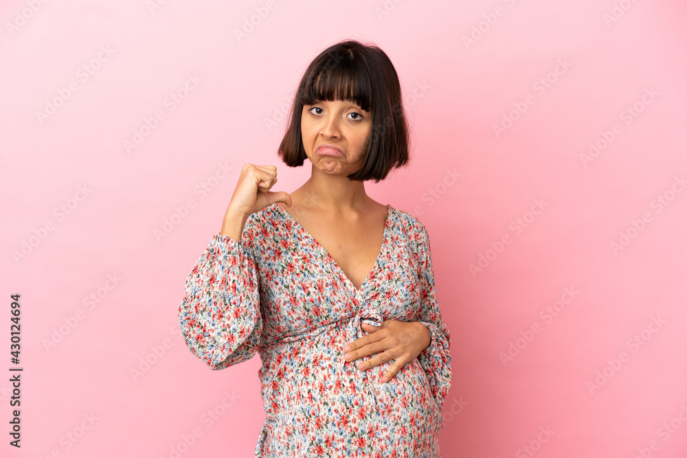 Young pregnant woman over isolated pink background proud and self-satisfied Young pregnant woman over isolated pink background proud and self-satisfied