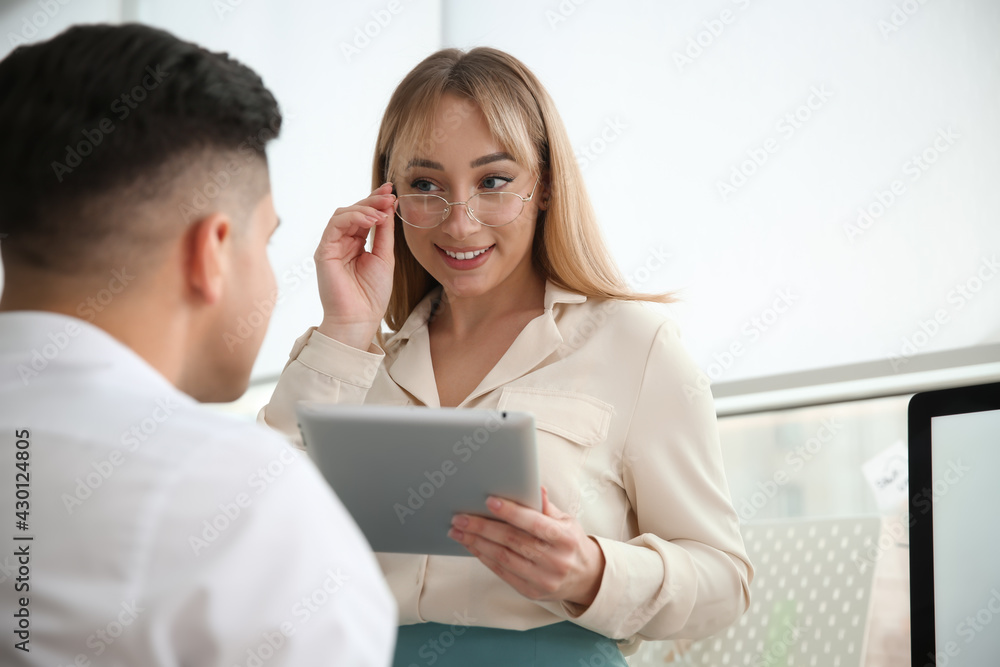 Colleagues flirting with each other during work in office Colleagues flirting with each other during work in office