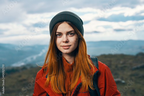 portrait of a woman in warm clothes in the mountains in autumn landscape tourism © SHOTPRIME STUDIO