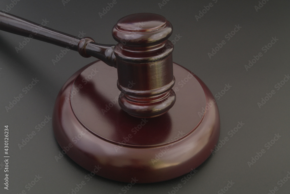 Wooden judge gavel on black table close up, legal and law concept.