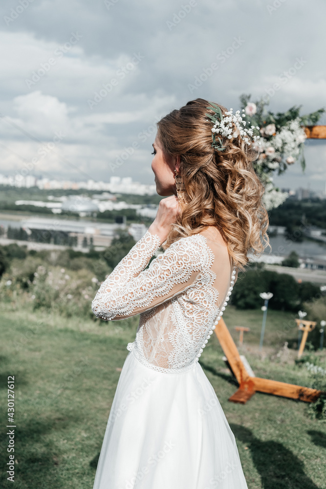 lovely beautiful young slender bride in an airy elegant white wedding dress with lace smile gentle portrait 