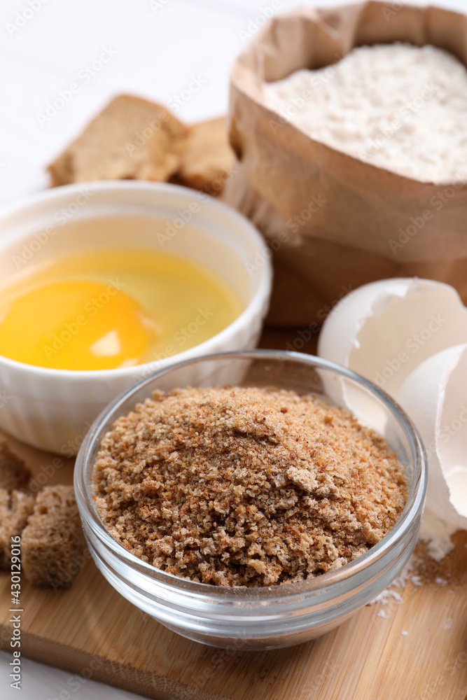 Fresh breadcrumbs, flour and egg on table Fresh breadcrumbs, flour and egg on table