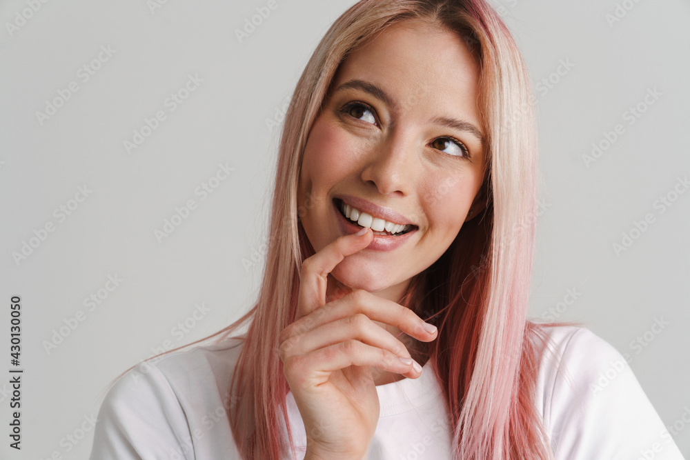 Young woman with pink hair smiling and looking aside Young woman with pink hair smiling and looking aside