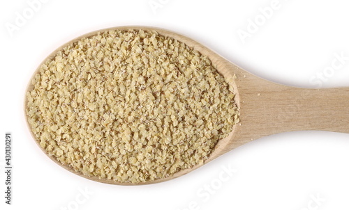 Wheat germ pile in wooden spoon isolated on white background, top view