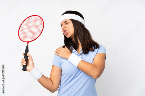 Young badminton player woman over isolated white background suffering from pain in shoulder for having made an effort © luismolinero