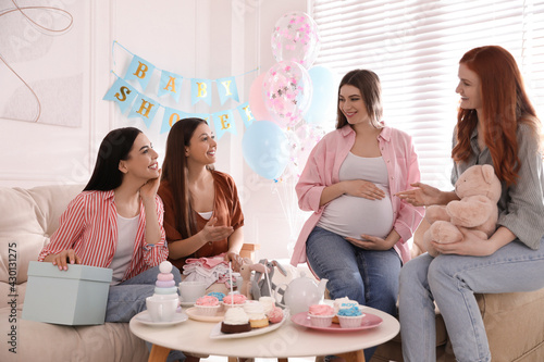 Fotografie Happy pregnant woman spending time with friends at baby shower party