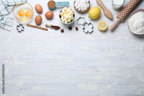 Cooking utensils and ingredients on white wooden table, flat lay. Space for text
