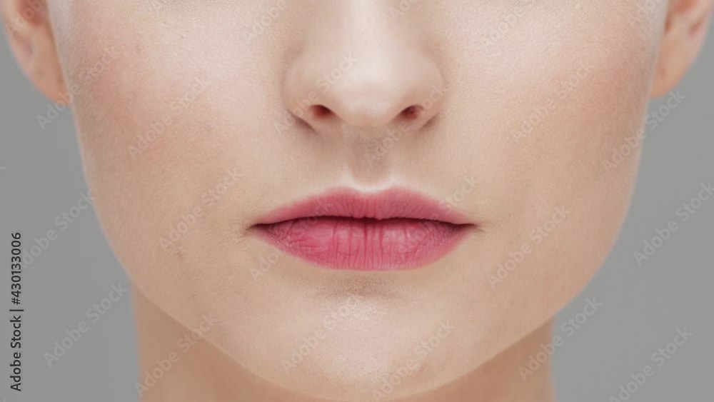 Studio portrait of young, beautiful and natural woman over grey background. Face lifting, cosmetics and make-up. Studio portrait of young, beautiful and natural woman over grey background. Face lifting, cosmetics and make-up.