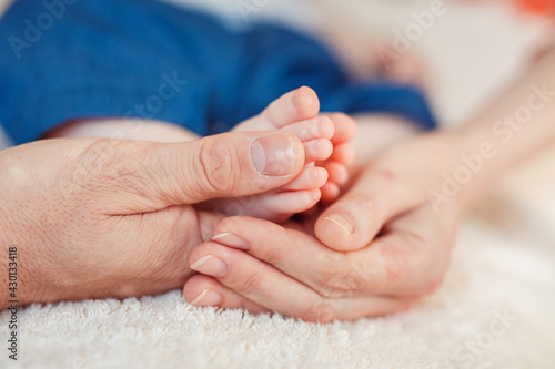 Baby foot in mother hands.