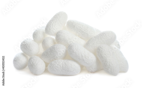 Pile of natural silkworm cocoons on white background