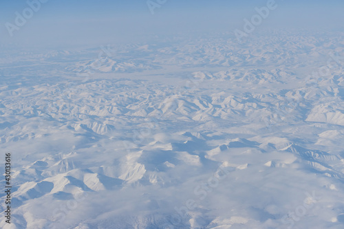 Aerial view of snow-capped mountains. Winter snowy mountain landscape. Great for backgrounds.