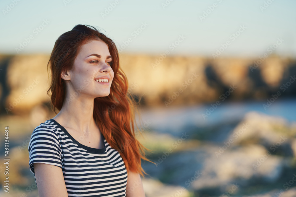 joyful woman in mountains outdoors and striped t-shirt landscape mountains sea river