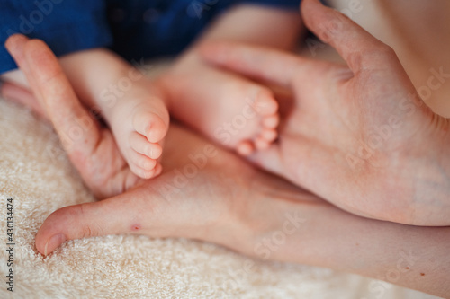 Baby foot in mother hands.