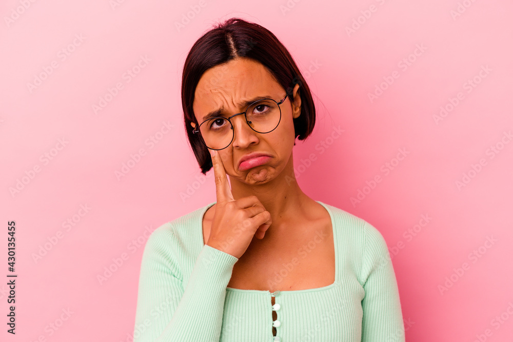 Obraz premium Young mixed race woman isolated on pink background crying, unhappy with something, agony and confusion concept.