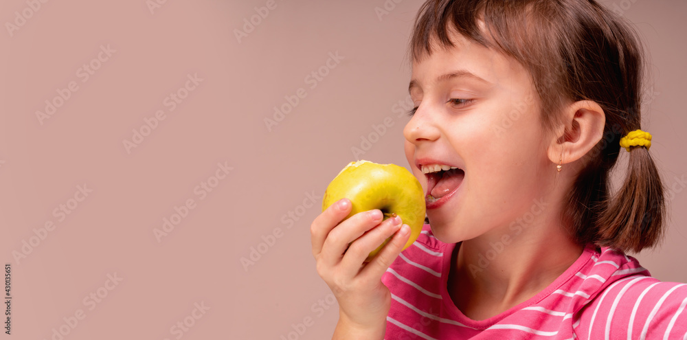 Profile portrait of a happy child girl with apple as symbol of diet and healthy food. Copy space for design. Profile portrait of a happy child girl with apple as symbol of diet and healthy food. Copy space for design.