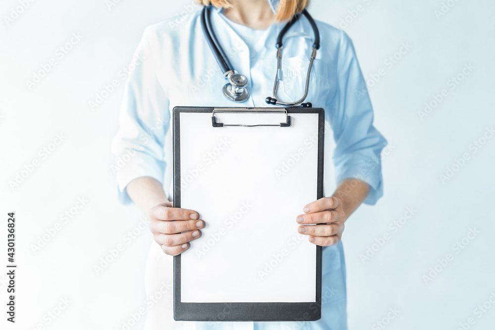 Female doctor with stethoscope holding clipboard in the hospital. Female doctor with stethoscope holding clipboard in the hospital.
