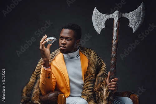 Photography Bizarre african guy with huge axe and diamond
