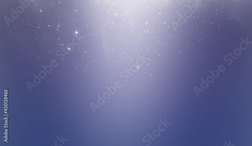 Abstract blue background. White bokeh or dust on a blue background.