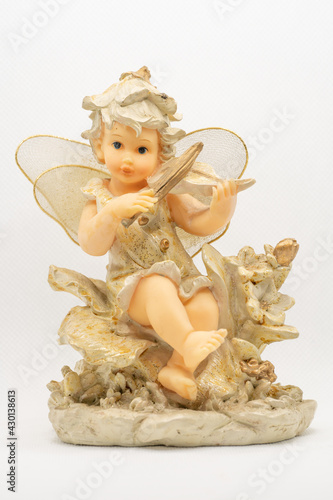 figure of a little angel with wings playing the violin