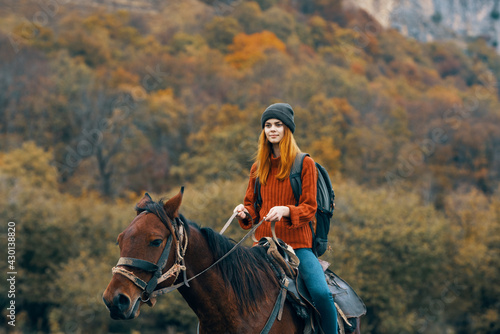 woman hiker riding a horse in the mountains walk fresh air travel