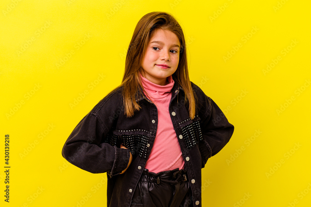 Little caucasian girl isolated on yellow background dreaming of achieving goals and purposes Little caucasian girl isolated on yellow background dreaming of achieving goals and purposes