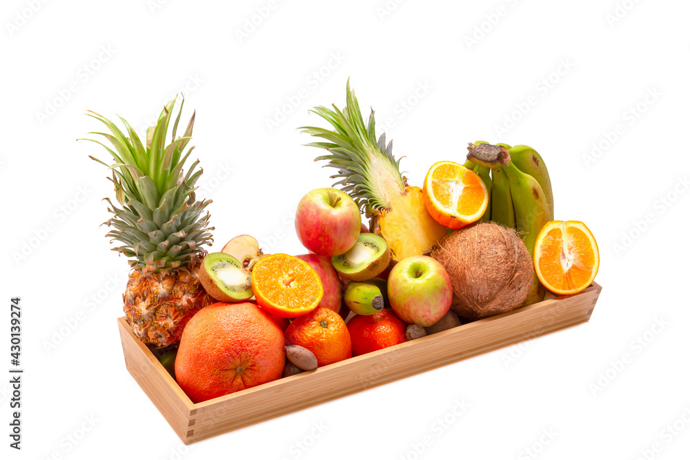 Healthy eating. Set of fresh tropical fruits in a wooden tray. On a white isolated background.