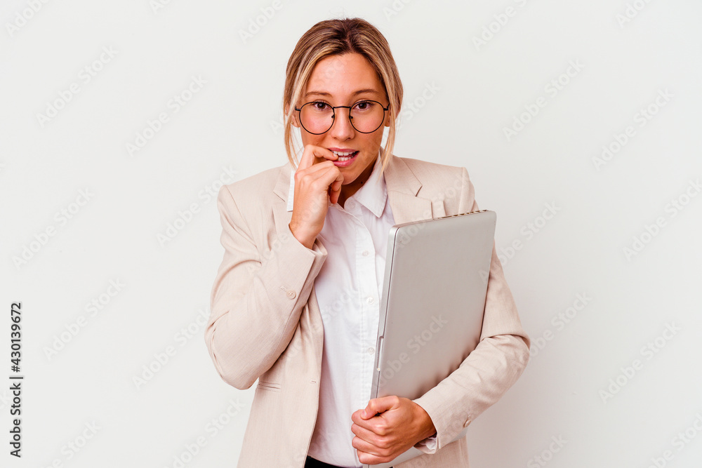 Young caucasian business woman holding a laptop isolated on white background biting fingernails, nervous and very anxious. Young caucasian business woman holding a laptop isolated on white background biting fingernails, nervous and very anxious.