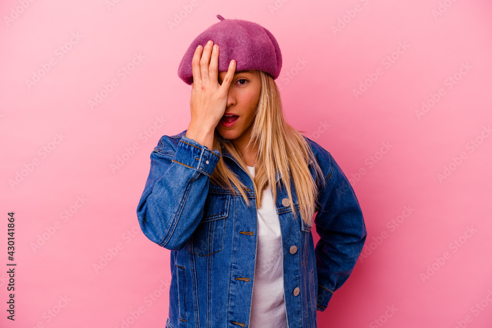 Young mixed race woman isolated on pink background having fun covering half of face with palm. Young mixed race woman isolated on pink background having fun covering half of face with palm.