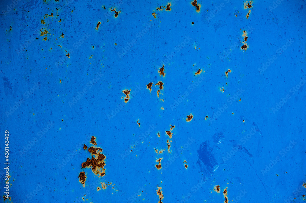 background metal surface with burnt out blue paint and rusty metal