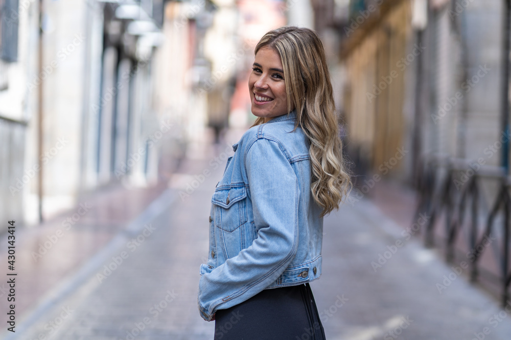 Caucasian young woman dressed in denim jacket