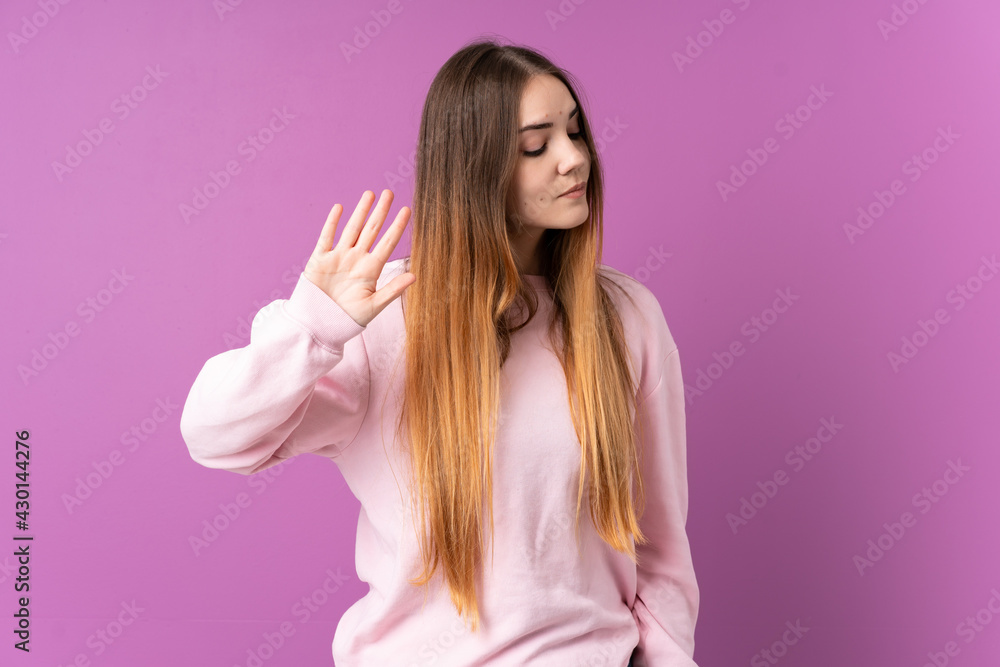 Young caucasian woman isolated on purple background making stop gesture and disappointed Young caucasian woman isolated on purple background making stop gesture and disappointed