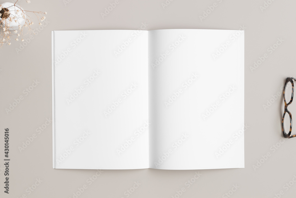 Open magazine mockup with a glasses and gypsophila on the beige table. Open magazine mockup with a glasses and gypsophila on the beige table.