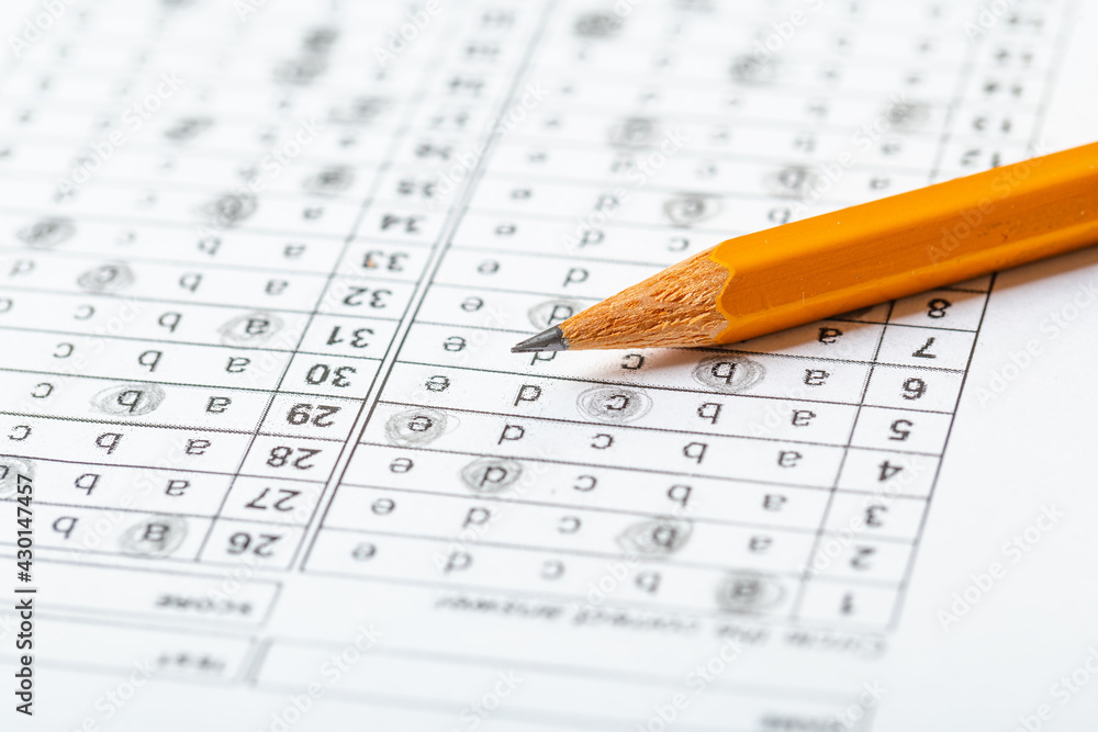 testing in exercise and exam paper. computer sheet with pencil in school test room, education concept. filling in answers in pencil testing in exercise and exam paper. computer sheet with pencil in school test room, education concept. filling in answers in pencil