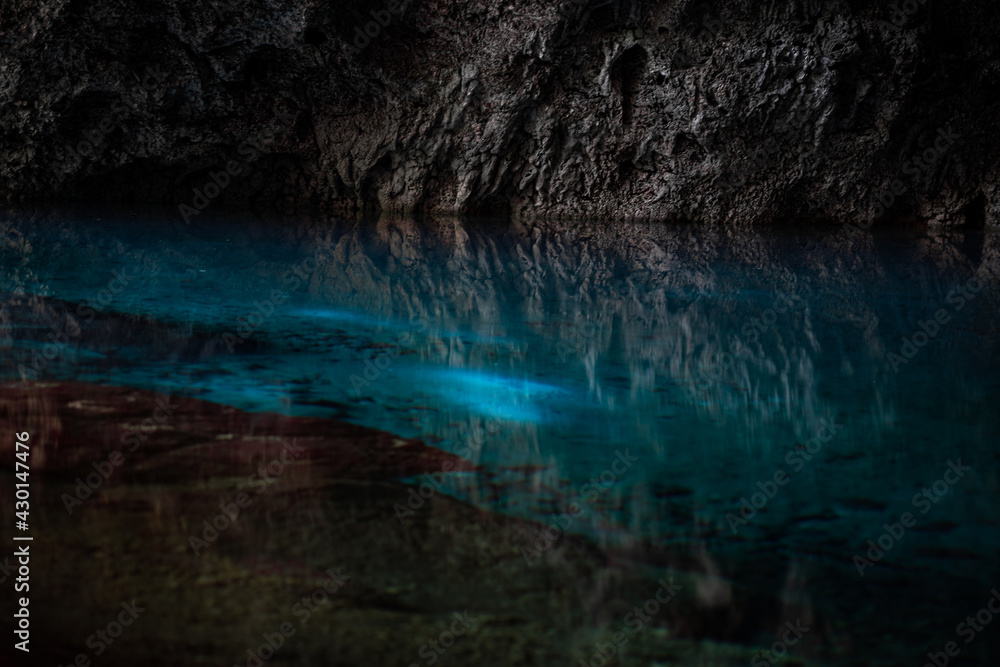 Light descends into the darkness of a submerged cavern with blue lake. Concept of travel and adventure. Light descends into the darkness of a submerged cavern with blue lake. Concept of travel and adventure.