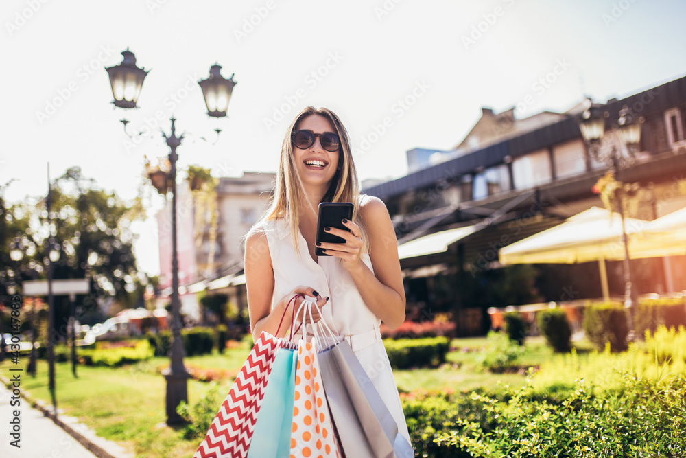 Young woman with shopping bags walking around the city