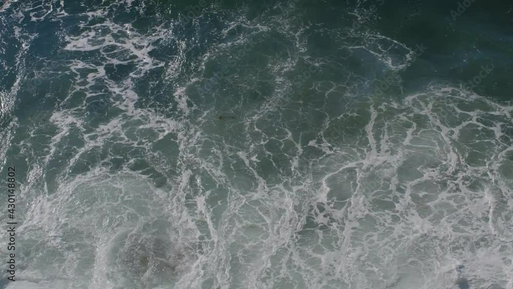 Top view of the ocean on a sunny day. Blue water waves surface, beautiful background with copy space. Environmental problems, lack of drinking water, climate change, drought, global warming. Top view of the ocean on a sunny day. Blue water waves surface, beautiful background with copy space. Environmental problems, lack of drinking water, climate change, drought, global warming.
