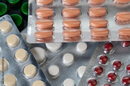 Different pills, tablet's blisters and capsules background. Pharmacalogical concept photo