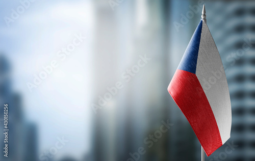 A small flag of Czechia on the background of a blurred background