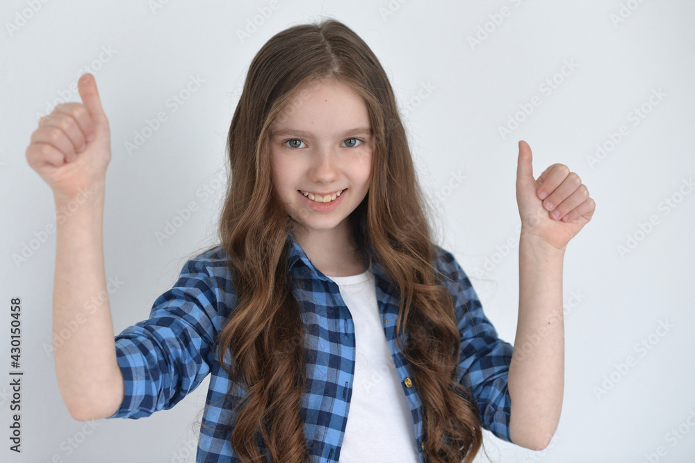 Cute girl with thumbs up posing isolated on white background Cute girl with thumbs up posing isolated on white background