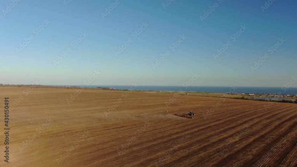 Aerial view Harvester machines working in field. Top view from the drone Combine harvester agricultural machine plowed field. Aerial view Harvester machines working in field. Top view from the drone Combine harvester agricultural machine plowed field.