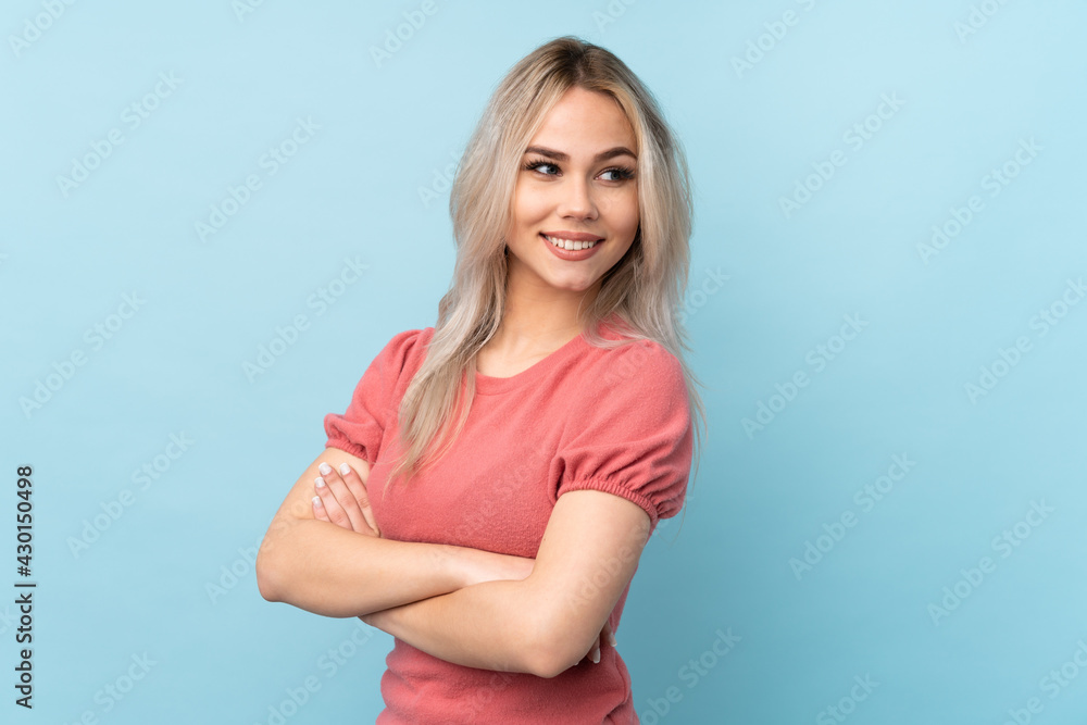 Teenager girl over isolated blue background with arms crossed and happy Teenager girl over isolated blue background with arms crossed and happy