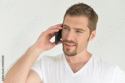 Portrait of handsome young man talking on smartphone