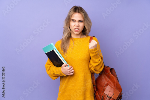 Teenager Russian student girl isolated on purple background frustrated by a bad situation