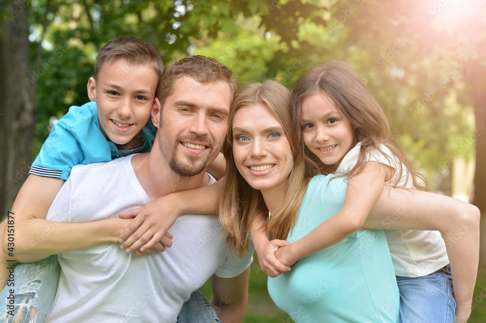 Portrait of happy young family in summer park Portrait of happy young family in summer park